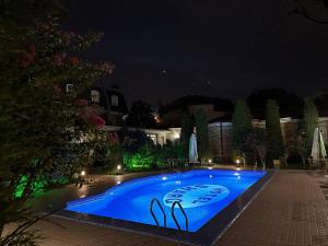 a large blue swimming pool at night at HL 309 Hotel in Tashkent