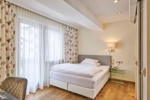 Voodi või voodid majutusasutuse Hotel Garni Sursilva toas