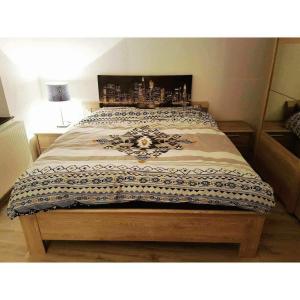 a bedroom with a large bed with a wooden frame at chouette appartement 2 chambres in Seraing