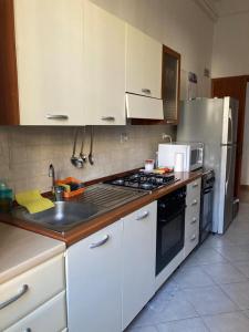 a kitchen with a sink and a stove top oven at Interno 3 in Rome