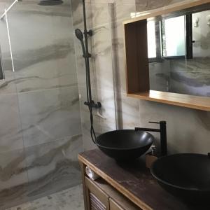 a bathroom with a sink and a shower at L arbousiere in Sagriès