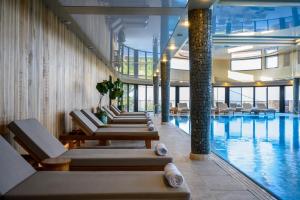 a hotel pool with lounge chairs and a swimming pool at Cnaan Hotel- Limited Edition By Fattal in Safed