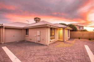 a house with a brick driveway in front of it at Seaside Sanctuary Port Noarlunga in Port Noarlunga South