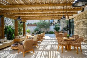 a patio with chairs and tables at Cnaan Hotel- Limited Edition By Fattal in Safed