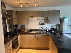 a kitchen with a sink and a counter top at Heronsgate GH014 in Belvedere