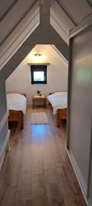 a attic room with two beds and a table at Polderrust in De Haan +5 photos