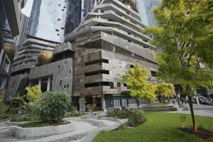 a large building in the middle of a city at Brand New 2BR Apt at Mel CBD in Melbourne