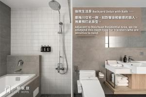 a bathroom with a shower and a toilet and a sink at 1LI7E Hotel in Taichung +39 photos