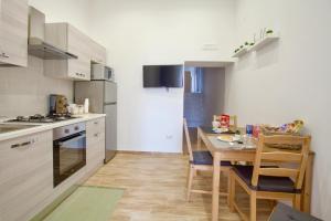 a kitchen with a wooden table and a dining room at Amabile casa vacanze in Naples