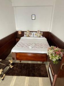 a small bedroom with a bed in a room at Monratino Ridge View in Gangtok