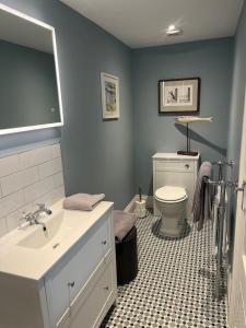 a bathroom with a sink and a toilet at Stunning Beachfront Apartment in Cleethorpes