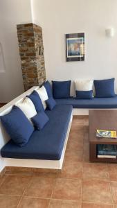 a blue couch sitting in a living room at andros prive suites in Kipri