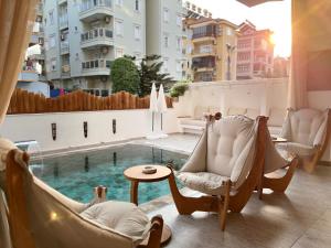 a balcony with chairs and a swimming pool at Oji Boutique Hotel in Alanya