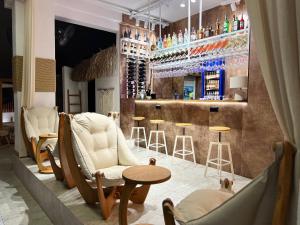 a bar with chairs and a counter with a bar at Oji Hotel in Alanya