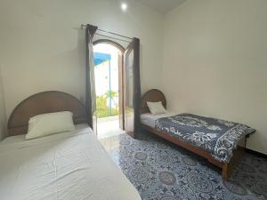 Postel nebo postele na pokoji v ubytování Gîte Hôtel Ramla Louxor