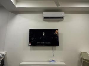 a flat screen tv hanging on a wall at TWC Luxury Seaview Suites Bali Residences Malacca in Melaka