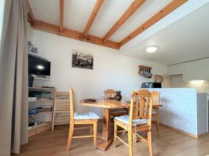a dining room with a wooden table and chairs at Appartement Vallouise-La Casse, 3 pièces, 6 personnes - FR-1-330G-25 in Le Poët