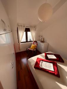 a bedroom with a bed with red napkins on it at Apartments Dijana in Kotor