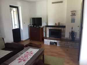 a living room with a couch and a fireplace at Villa Pahuljica in Jahorina
