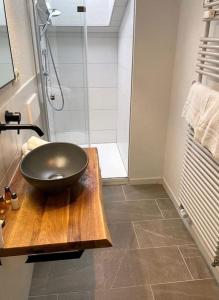 a bathroom with a black bowl sink on a wooden table at Ferienwohnung Erika in Oberstdorf