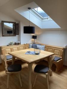 a dining room table with two chairs and a skylight at Ferienwohnung Erika in Oberstdorf