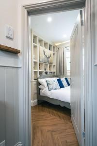 a bedroom with a bed and a door leading into a room at The Former New Inn in Ashby de la Zouch