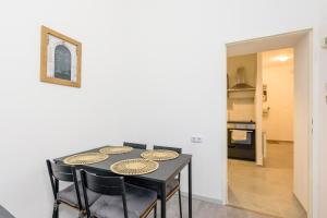 ein Esszimmer mit einem schwarzen Tisch und Stühlen in der Unterkunft Vienna Lights Apartments - Meidling in Wien + 55 Fotos