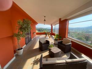 een grote kamer met oranje muren, stoelen en ramen bij La Casa di Tamy in Boville Ernica