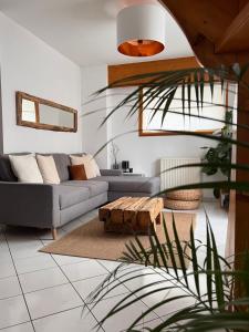 a living room with a couch and a table at Appartement Spacieux au Pays du Mont-Blanc in Sallanches