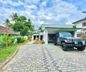 a truck parked in front of a house at Kandy Boutique Villa by Aaradhya in Kandy