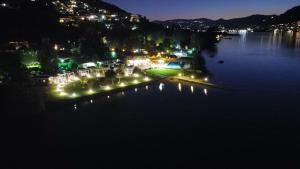 a view of a lake at night with lights at Belvedere Clusane Camping in Iseo