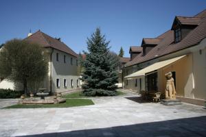 a courtyard of a house with a statue next to it at Hotel Baroko in Prague