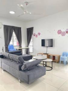 a living room with two couches and a tv at No7 Port Dickson Telok Kemang 15PAX BBQ Big Family in Port Dickson +43 photos