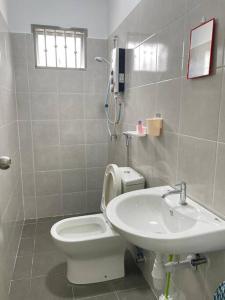 a bathroom with a toilet and a sink at No7 Port Dickson Telok Kemang 15PAX BBQ Big Family in Port Dickson