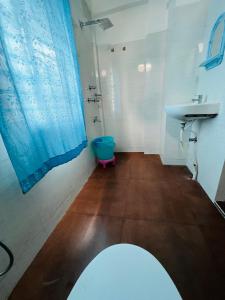 a bathroom with a toilet and a sink at Levi Home Guest House & Retreat Centre in Siliguri