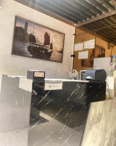 a counter in a room with a picture on the wall at Sleep Cubee Hostel in Hong Kong