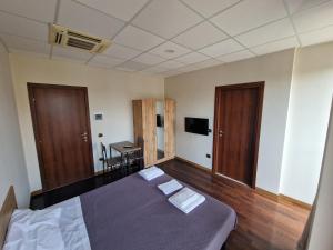 a bedroom with a bed with two doors and a desk at FRANK'S HOUSE in Viterbo