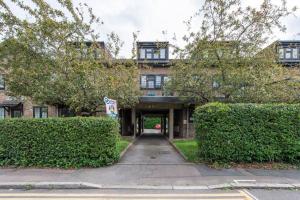 a building with a walkway in front of some bushes at 2 BR, Modern Urban Sanctuary in London