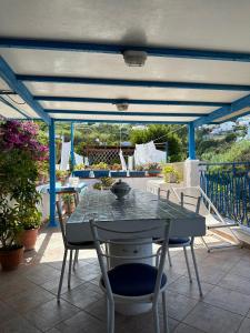 a patio with a table and chairs on a patio at Casa Talento in Ponza