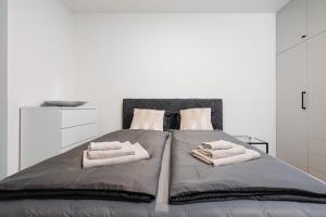 a bedroom with a bed with towels on it at Garden Apartment in Banská Bystrica