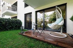 a hammock on a deck with a yard at Garden Apartment in Banská Bystrica