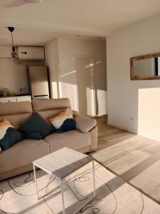 a living room with a couch and a table at Ático en el centro de Estella in Estella