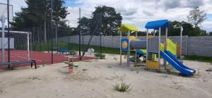 a playground with a slide and a play equipment at Apartament Bursztynowy in Jantar