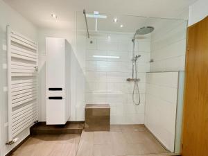 ein Badezimmer mit Dusche mit Glastür in der Unterkunft LIKE HOME, cozy apartment, 2 bedrooms, Netflix, 55" TV, balcony, parking, self-check-in in Penzberg + 30 Fotos