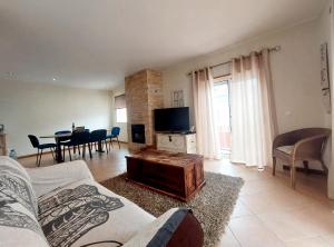a living room with a couch and a table at Casa Algarviana in São Bartolomeu de Messines