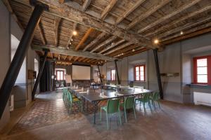 a large room with a long table and green chairs at La Casa del Mulino in Merone +67 photos