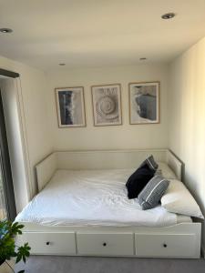 a bed with two pillows on it in a bedroom at Cosy bedroom in Luxury apartment in London