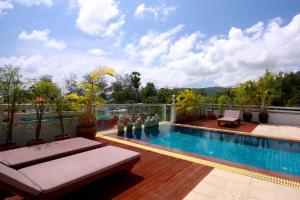 a swimming pool on the roof of a building at Rayaburi Hotel, Patong in Patong Beach