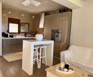 a kitchen and living room with a table and a couch at Cute house by the sea in Kriopigi