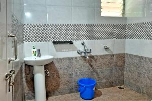 a bathroom with a sink and a shower at Hazel Retreat - Full Home & Coffee Estate in Chikmagalūr